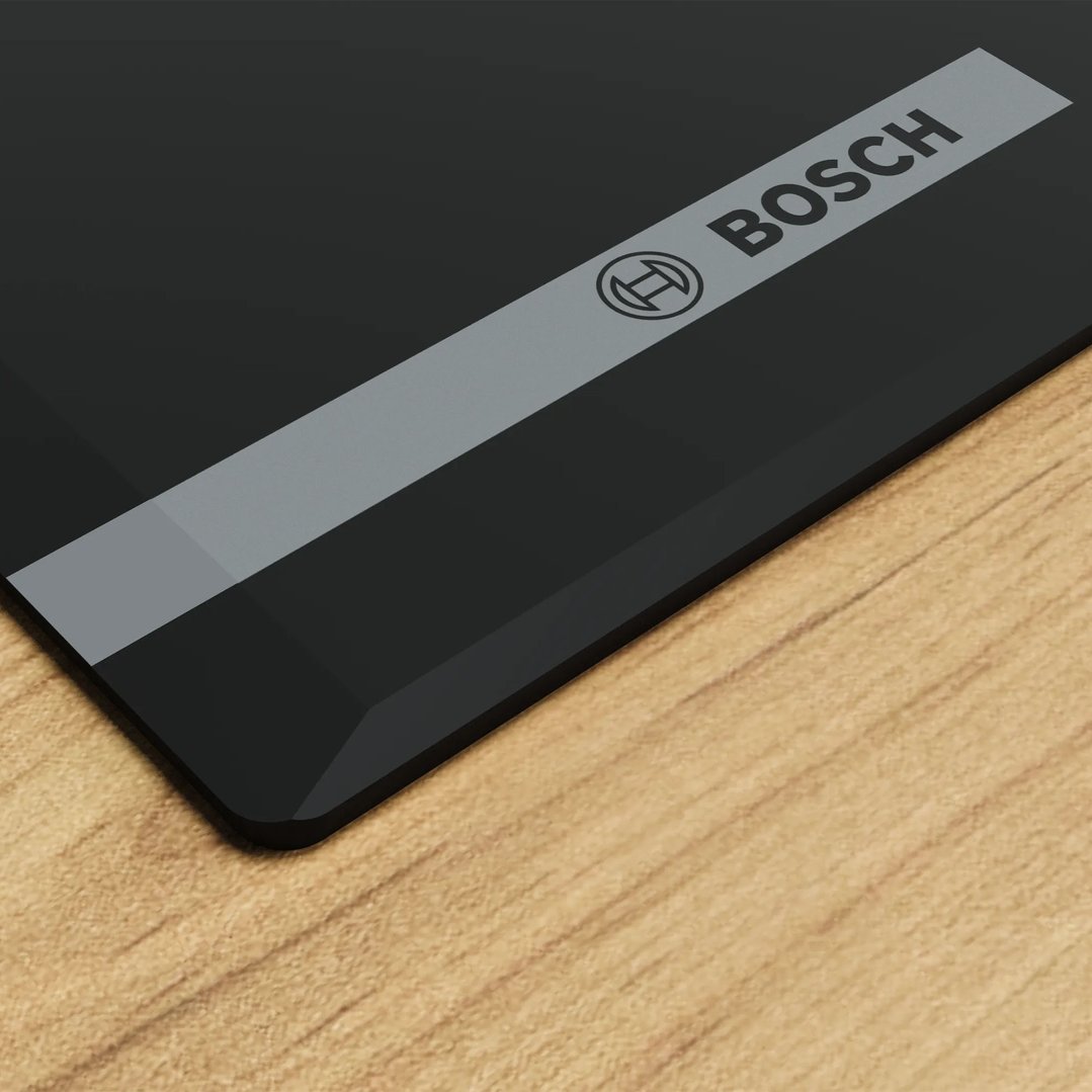 Bosch gas cooktop with tempered glass surface on a wooden countertop