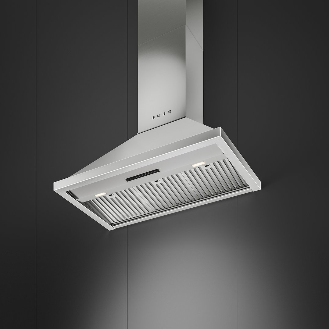 Stainless steel Smeg canopy rangehood with lights on, mounted on a dark wall