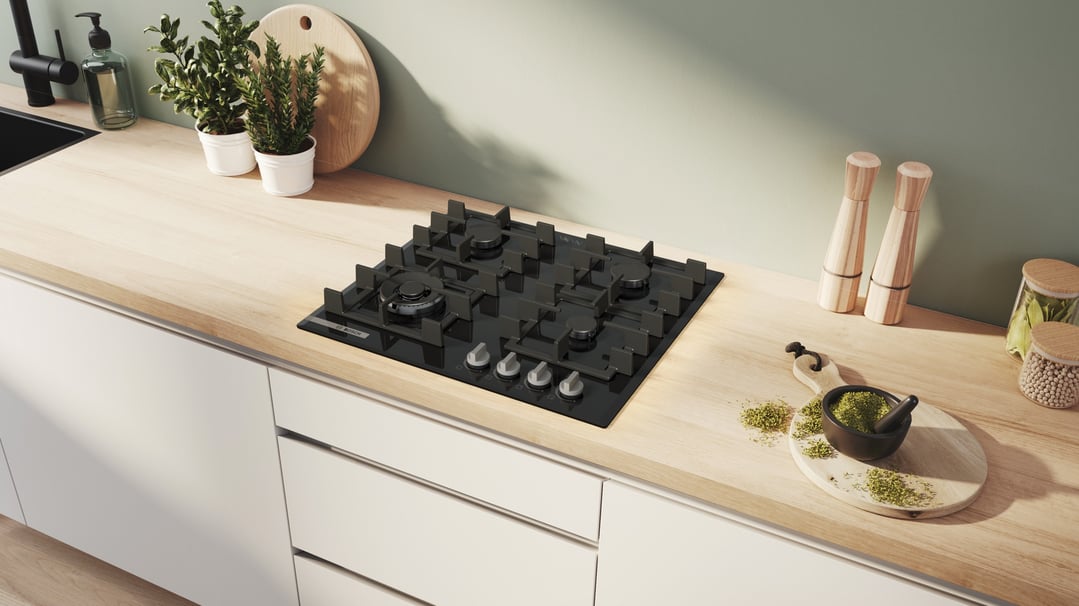 Black Bosch gas cooktop built into a light wood kitchen counter