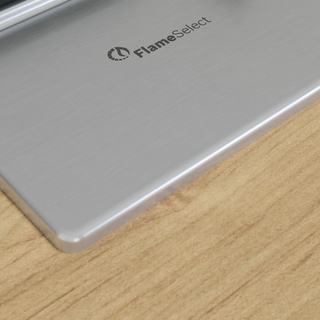 Close up of a stainless steel cooktop on a wooden countertop