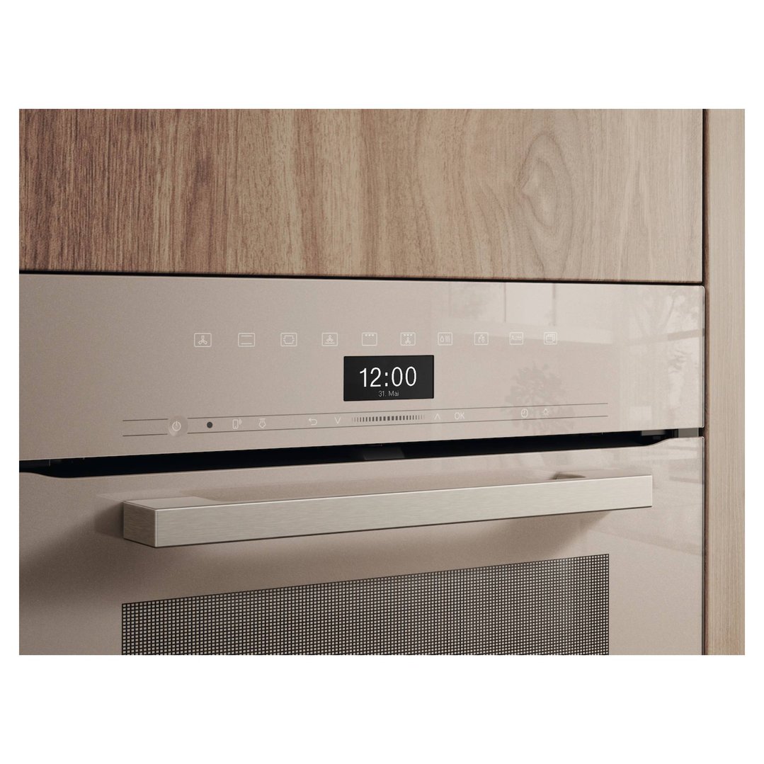 Built-in Miele oven with digital display showing 12:00, integrated into wooden cabinetry