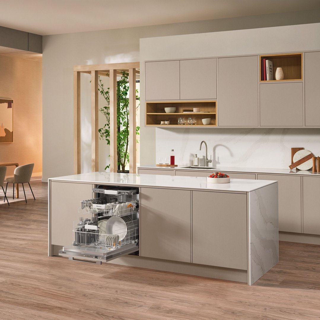 Integrated dishwasher in a modern kitchen island with dishes inside