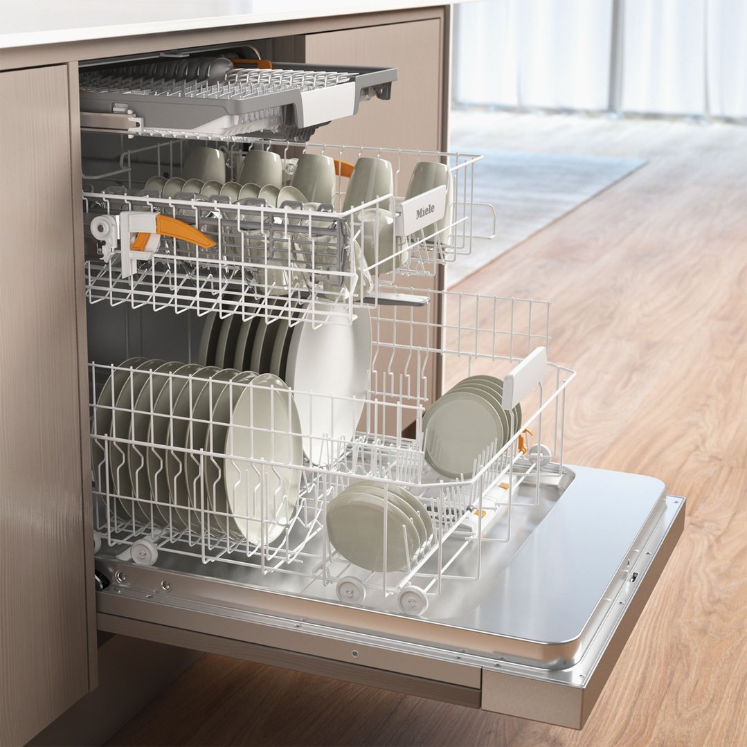 Open dishwasher with racks full of dishes in a kitchen setting