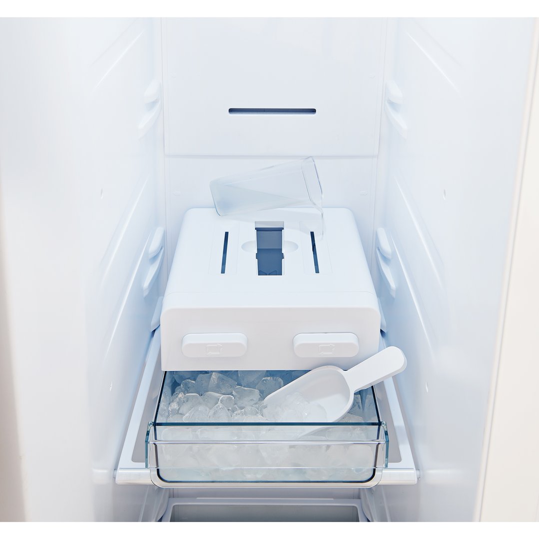 Interior view of a refrigerator with an ice maker and ice scoop