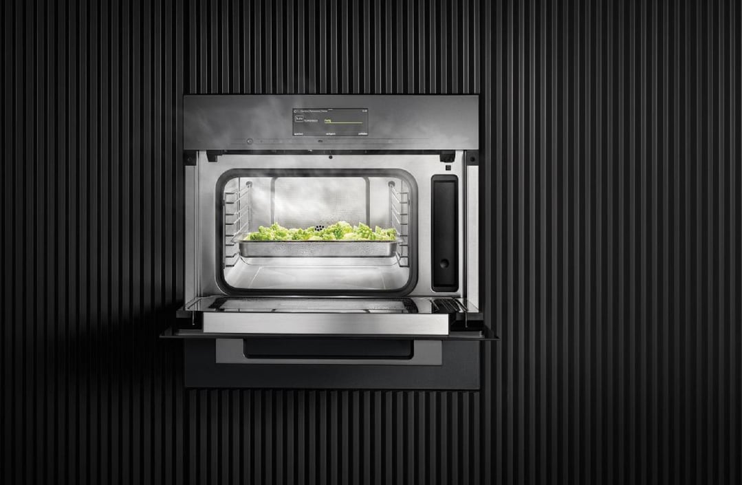 Steam oven with microwave cooking broccoli in a dark, ribbed wall setting