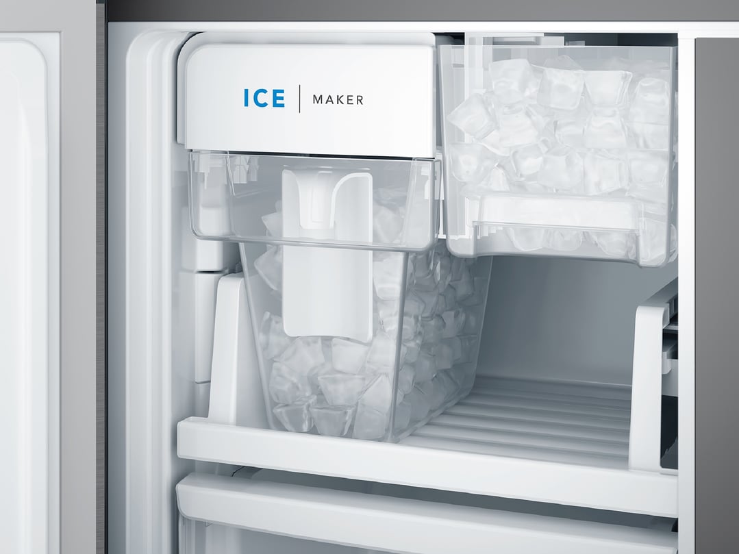 Close up of the ice maker and ice bucket inside a fridge