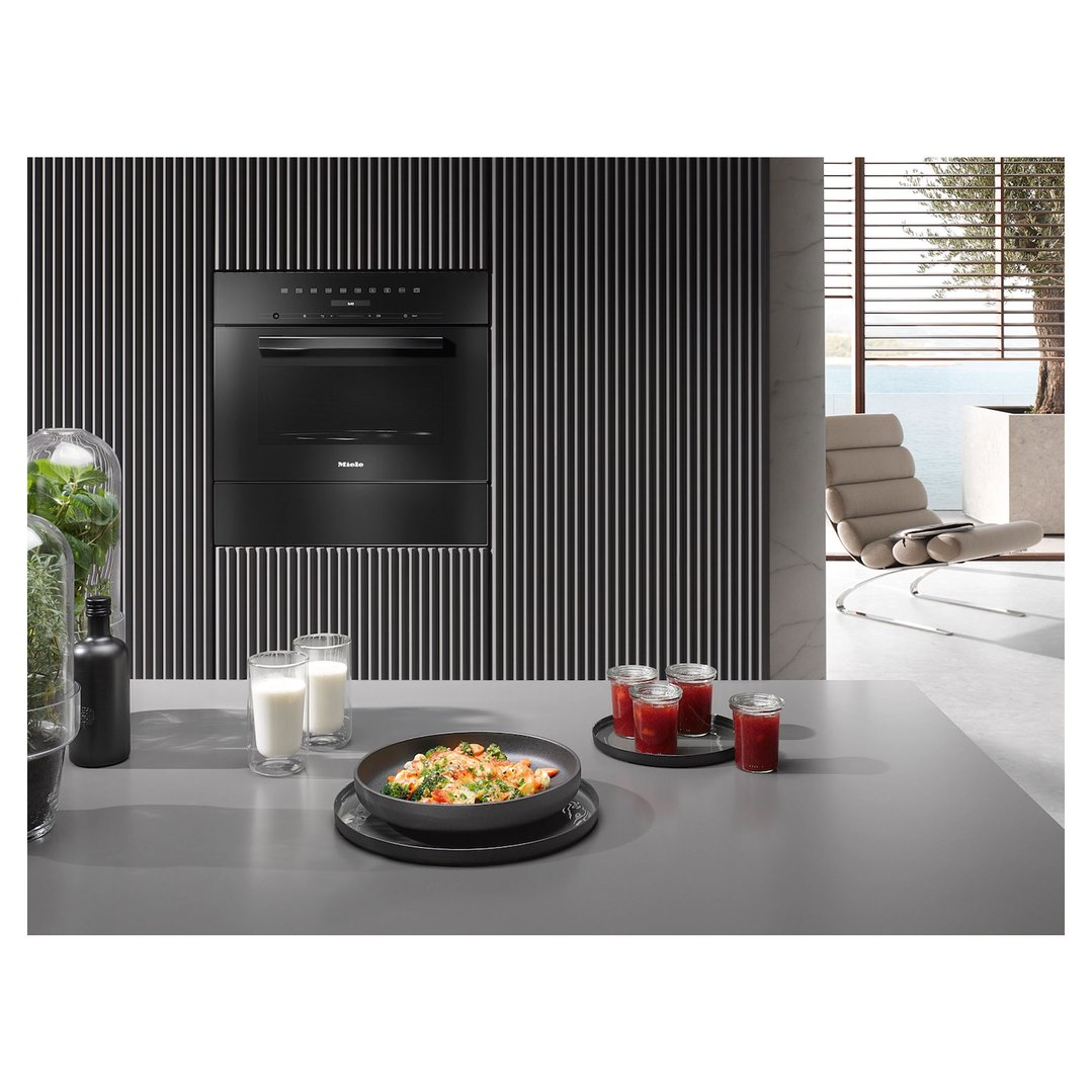 Built-in microwave in a modern kitchen with food and drinks on the counter