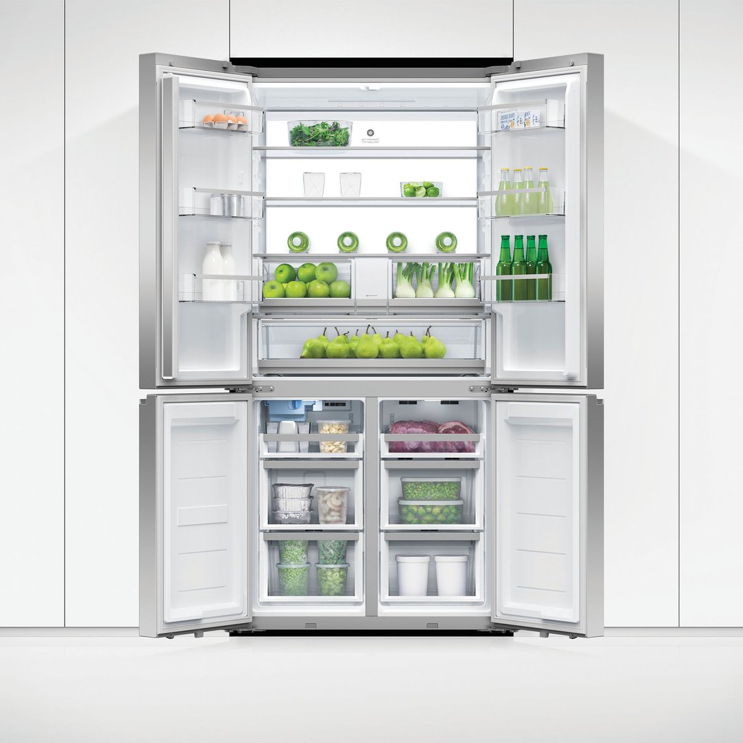 A quad door refrigerator freezer with all doors open, showing food inside