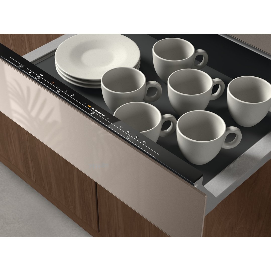 Open warming drawer with plates and cups inside, showing control panel