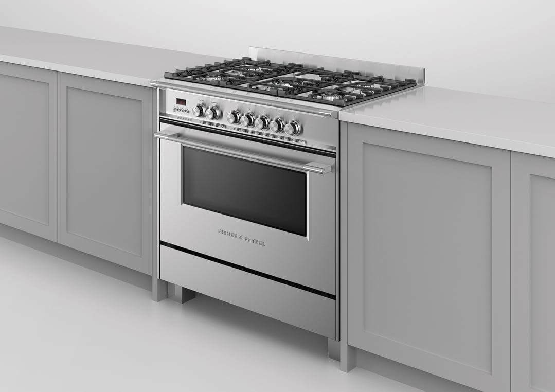 Stainless steel dual fuel cooker with five burners and oven in a modern kitchen