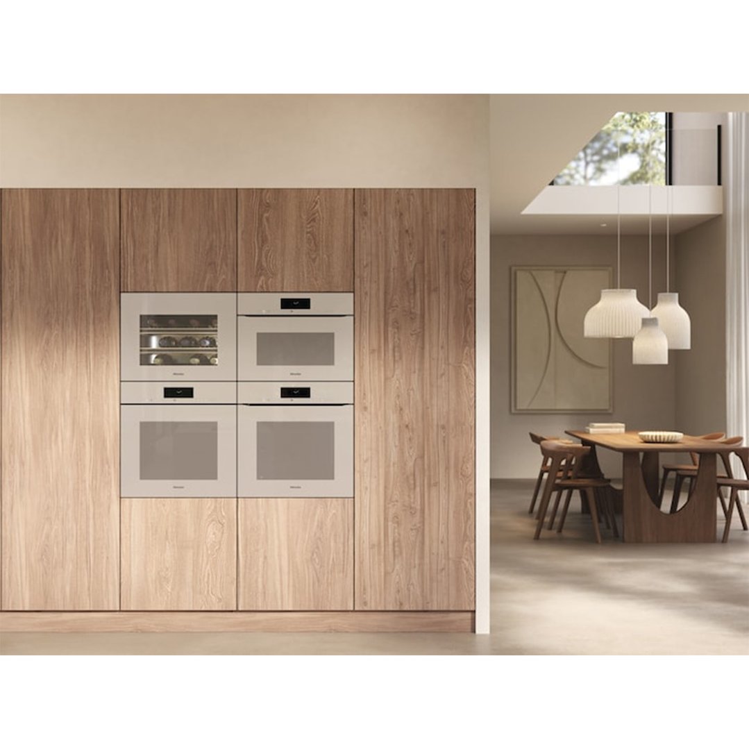 Built-in ovens and wine cooler in a wooden cabinet in a modern dining room