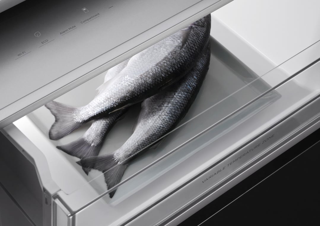 Three fish in the variable temperature zone drawer of a refrigerator freezer