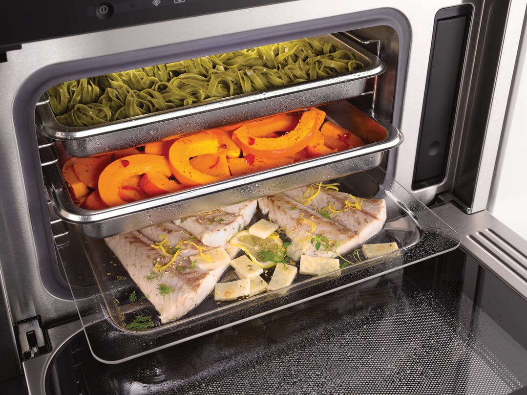 Close up of a Miele Steam Oven with Microwave cooking three dishes