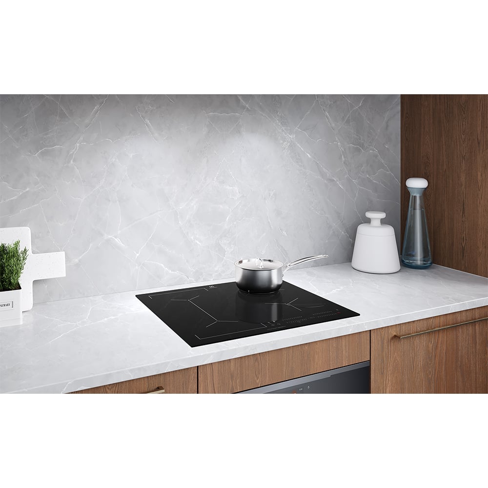 Induction cooktop with a pot on it, built into a kitchen counter