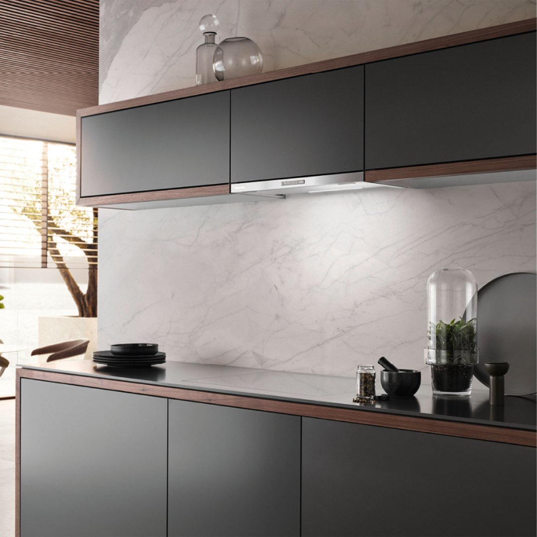 Miele 60cm slimline slideout rangehood installed above a cooktop in a modern kitchen