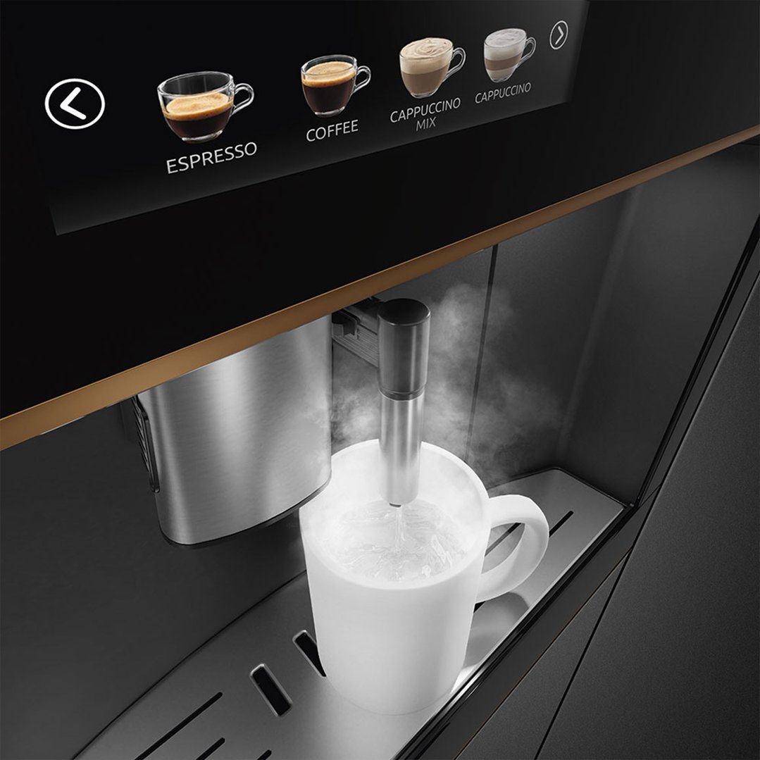 Built-in coffee machine dispensing hot water into a white mug