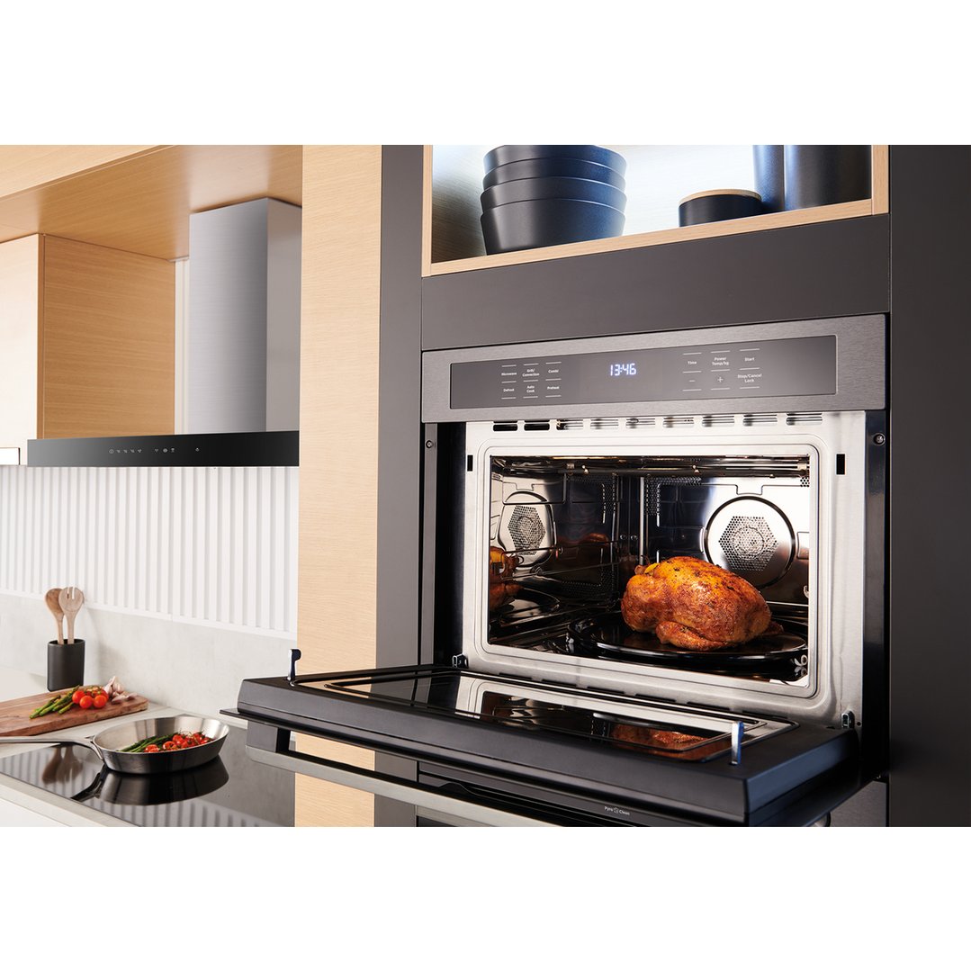 Built-in combination microwave with a roasted chicken inside, in a modern kitchen
