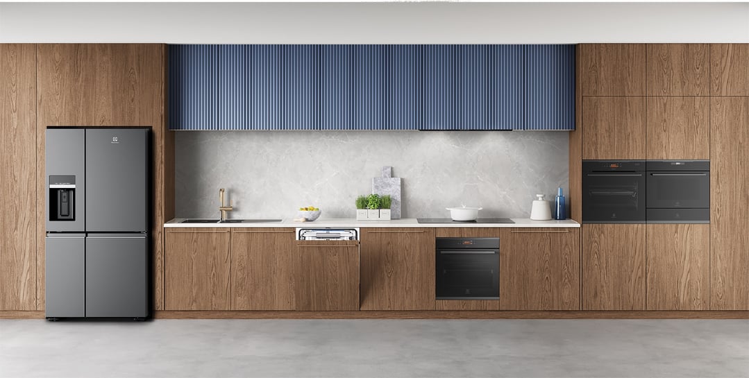 Modern kitchen with integrated dishwasher, refrigerator, ovens, and blue upper cabinets
