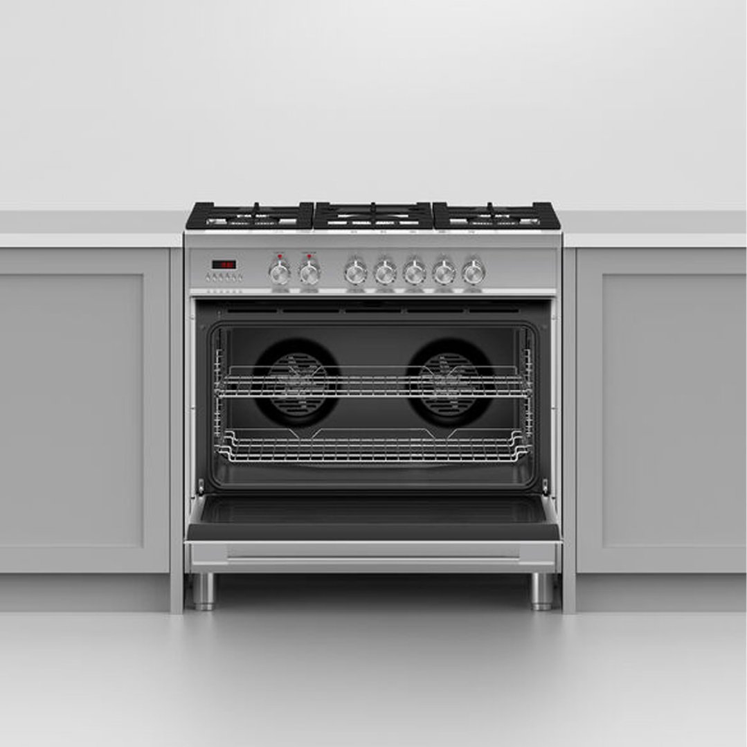Dual fuel cooker with open oven door in a kitchen setting