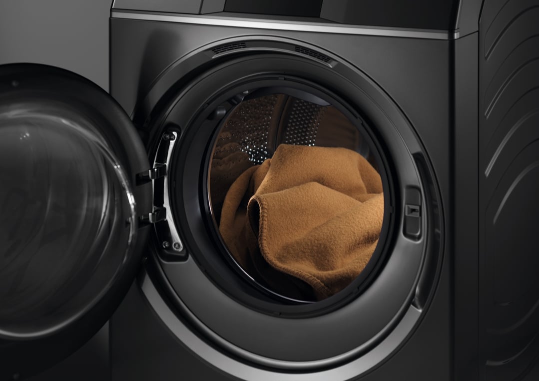 Close up of a dark washer dryer combo with the door open
