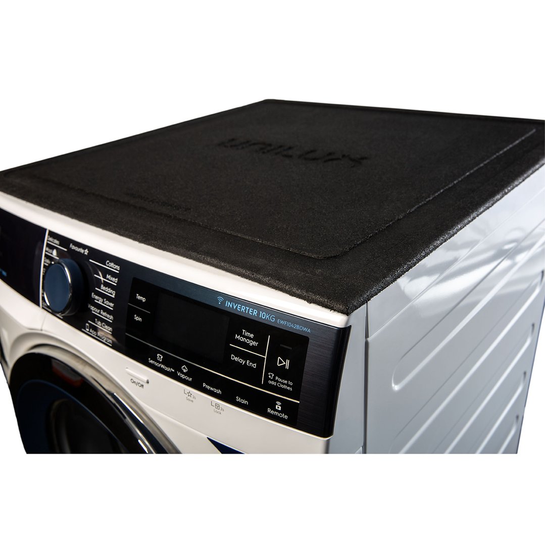 Black appliance mat on top of a white washing machine with control panel visible