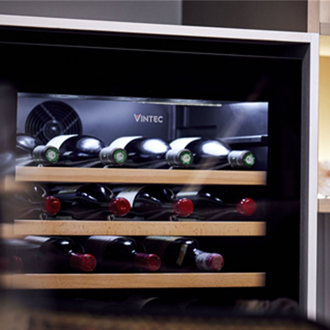 Close-up of a Vintec wine cabinet filled with wine bottles on wooden shelves