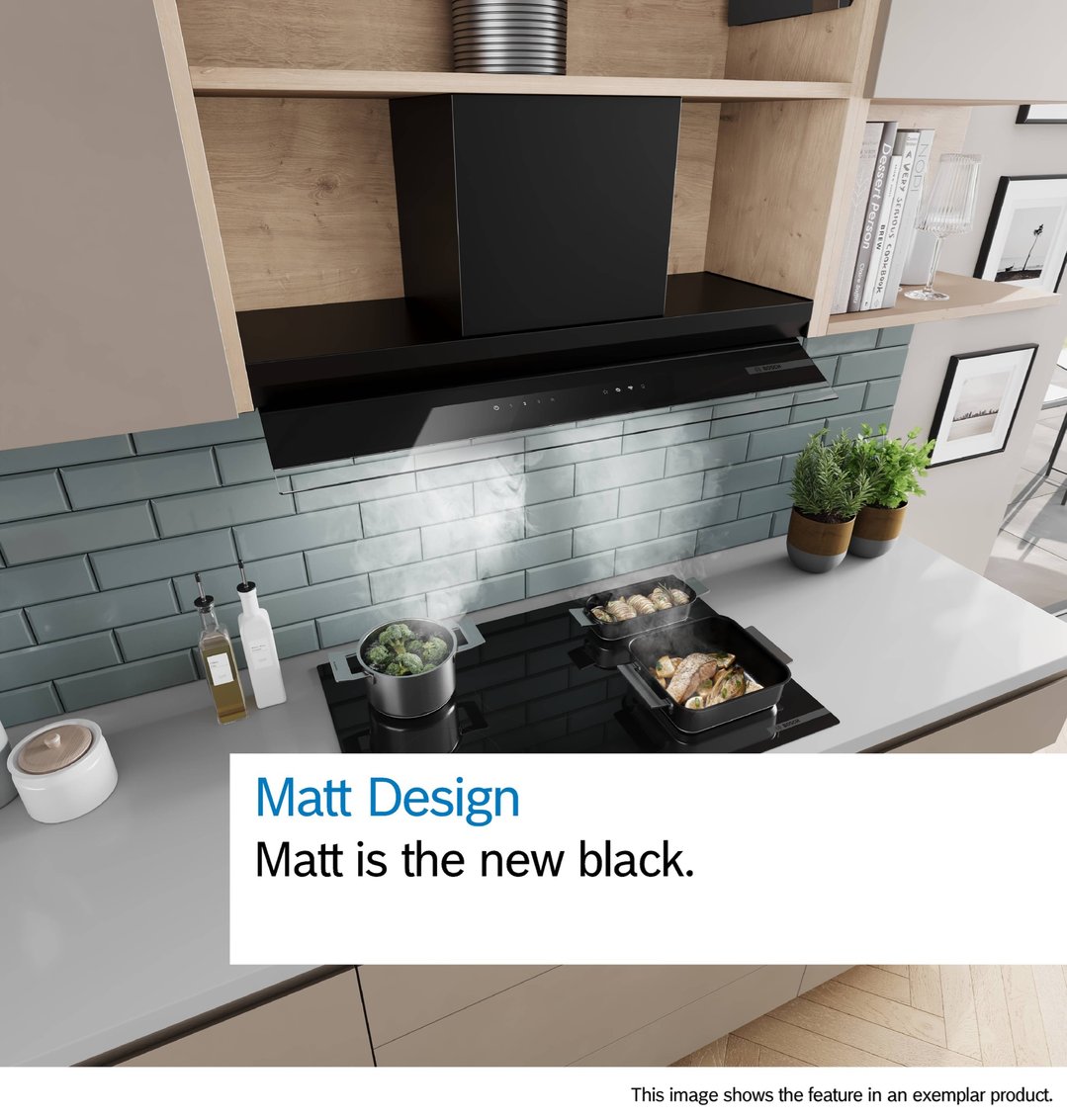 Black integrated rangehood above a cooktop with food cooking in a modern kitchen