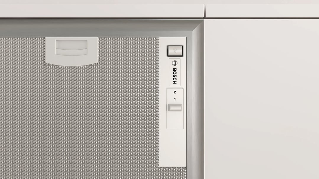 Close up of a Bosch integrated rangehood with controls and filter visible