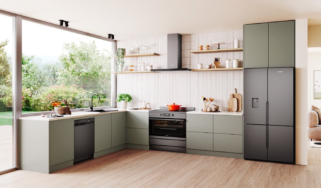 A matte charcoal black quad door fridge in a modern kitchen with green cabinets
