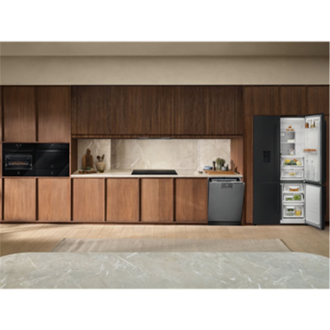 A black induction cooktop built into a modern kitchen with wooden cabinets