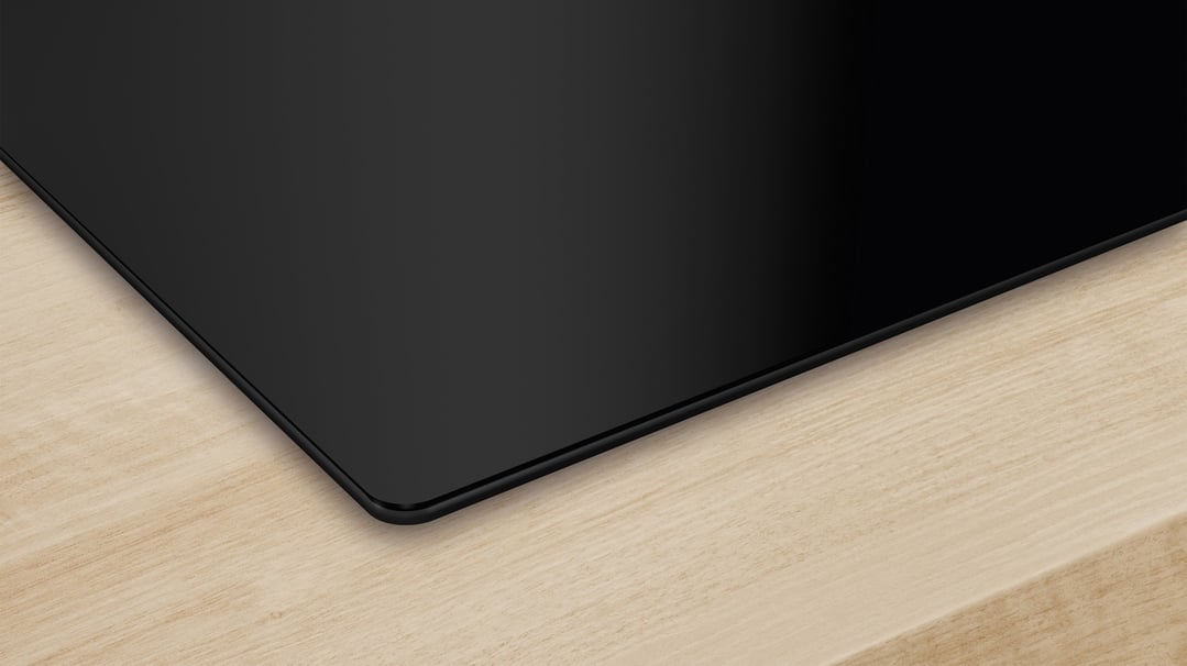 Black Bosch Series 4 induction cooktop on a light wooden countertop