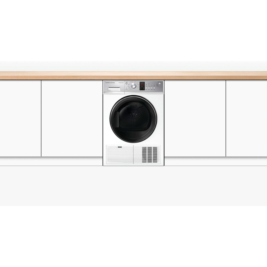White Fisher & Paykel 8kg condensing dryer installed under a wooden countertop