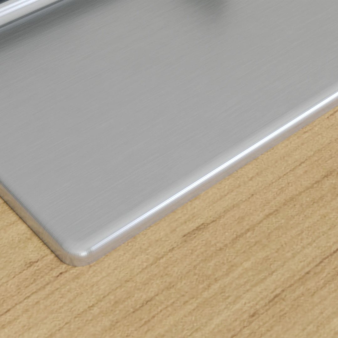 Close up of a stainless steel cooktop on a wooden countertop