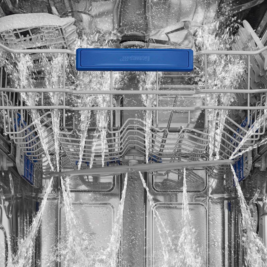 Inside a dishwasher with water spraying during a wash cycle