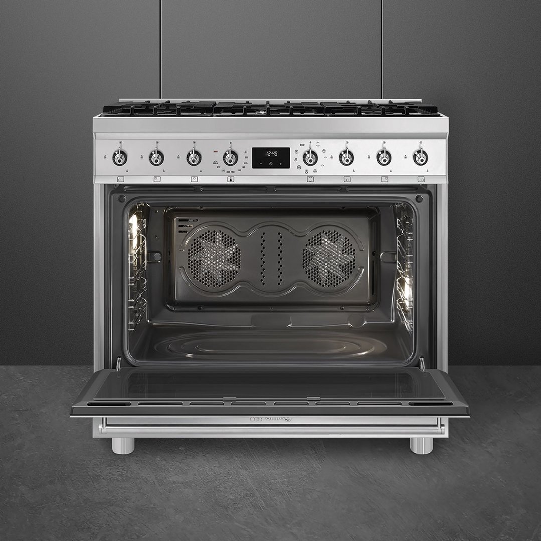 Stainless steel freestanding oven with door open, showing interior and controls