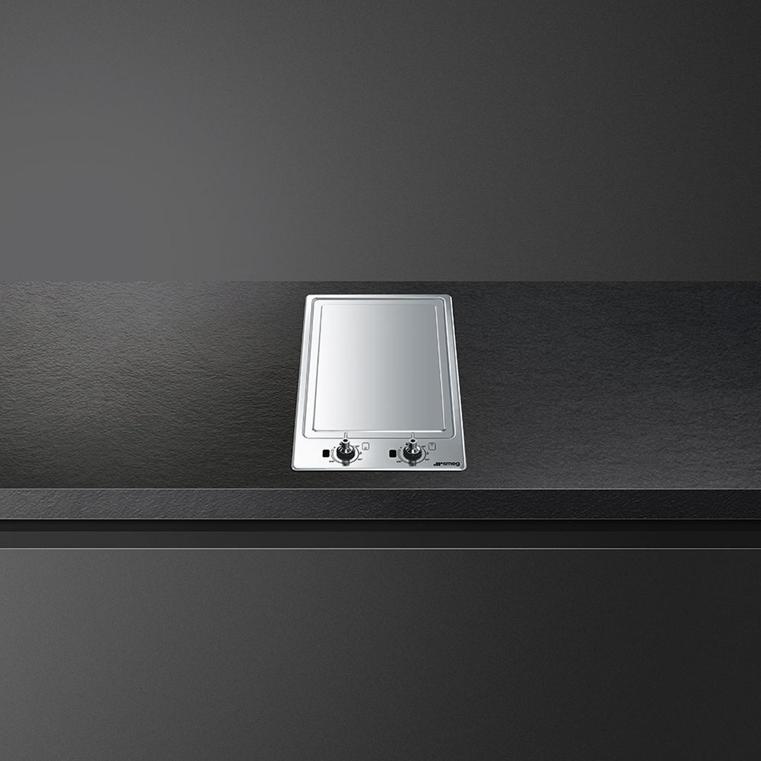 A built-in induction teppanyaki plate on a dark countertop