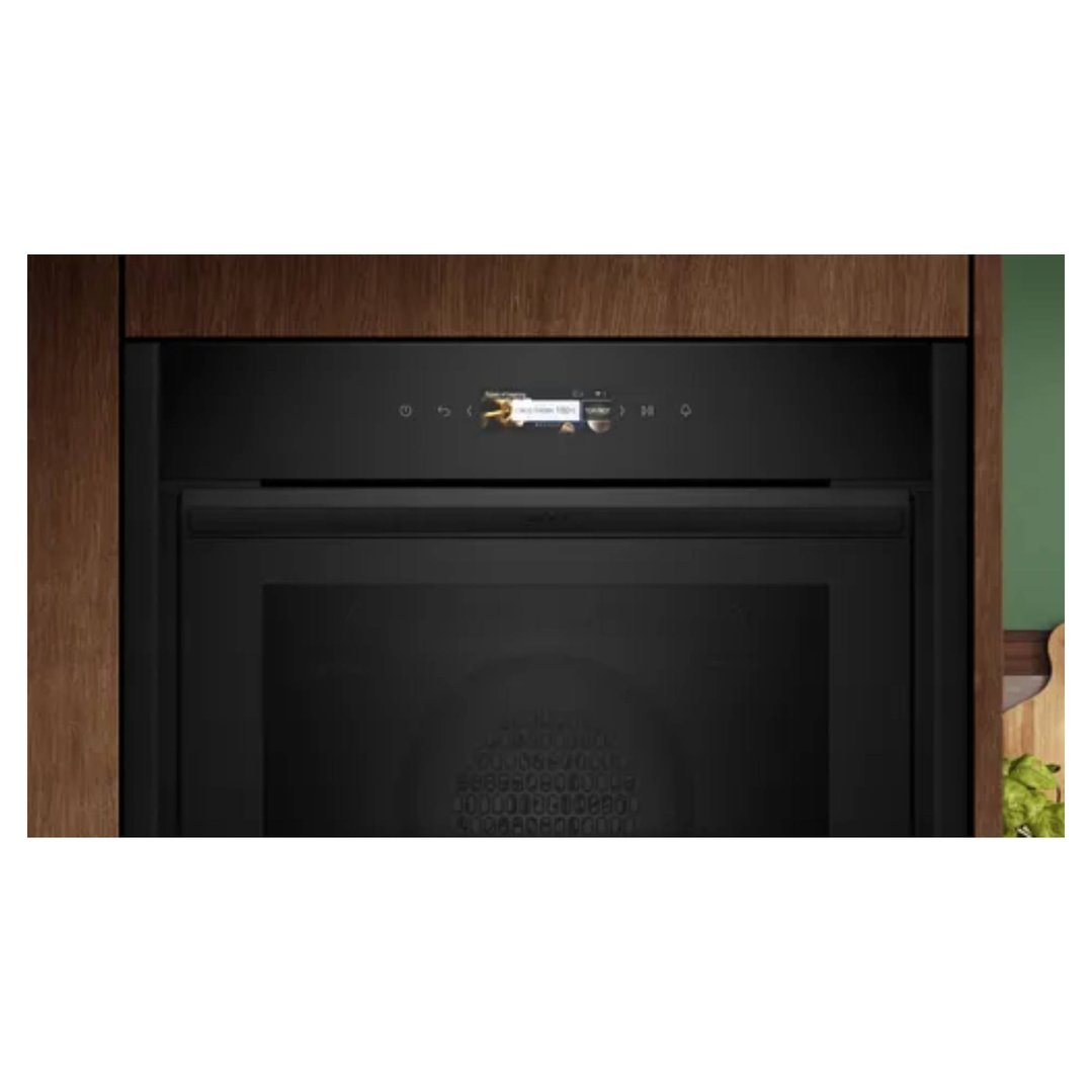 Built-in oven with a black finish and digital display, installed in a wooden cabinet