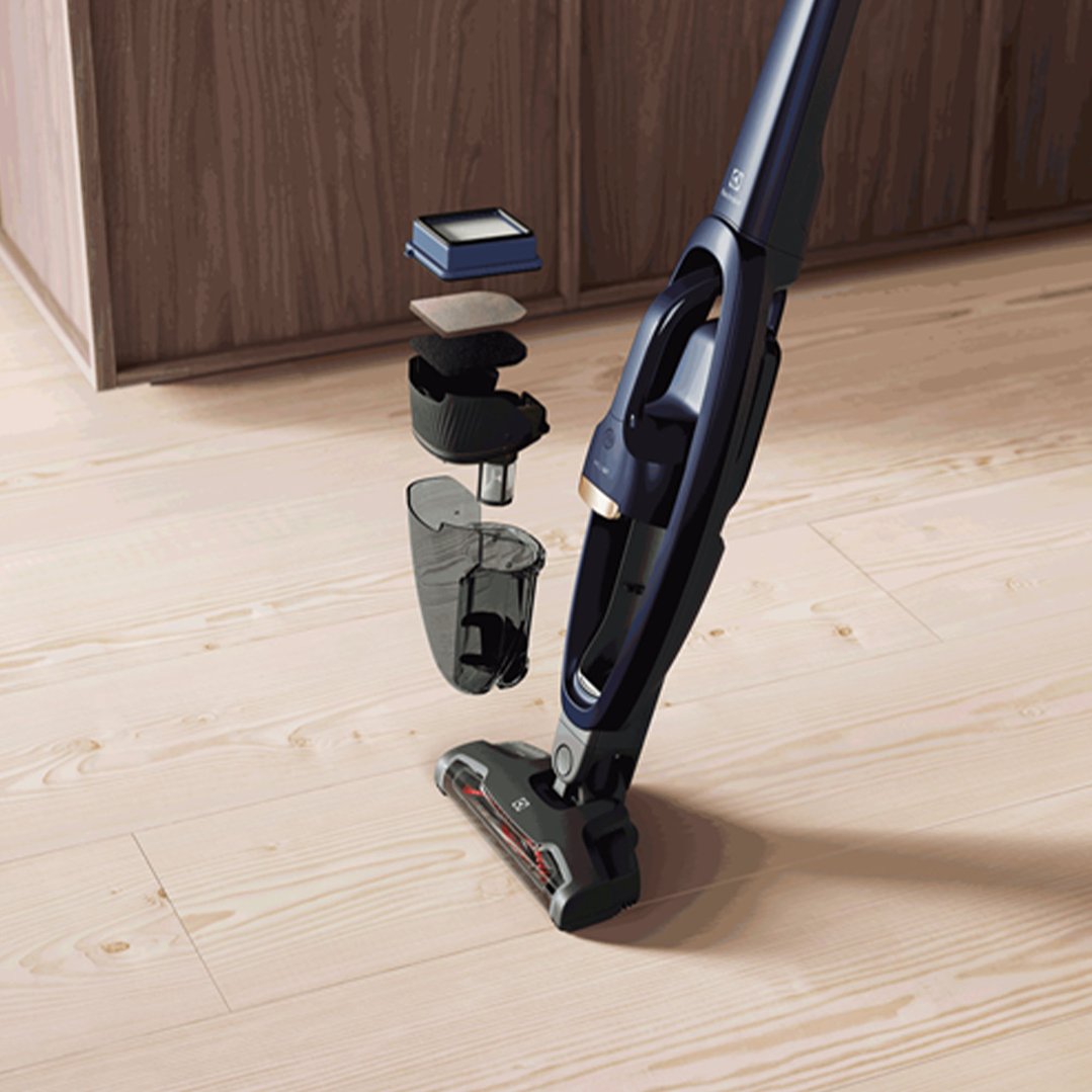 Electrolux Well Q7 Cordless Vacuum with exploded view of dustbin components on wooden floor