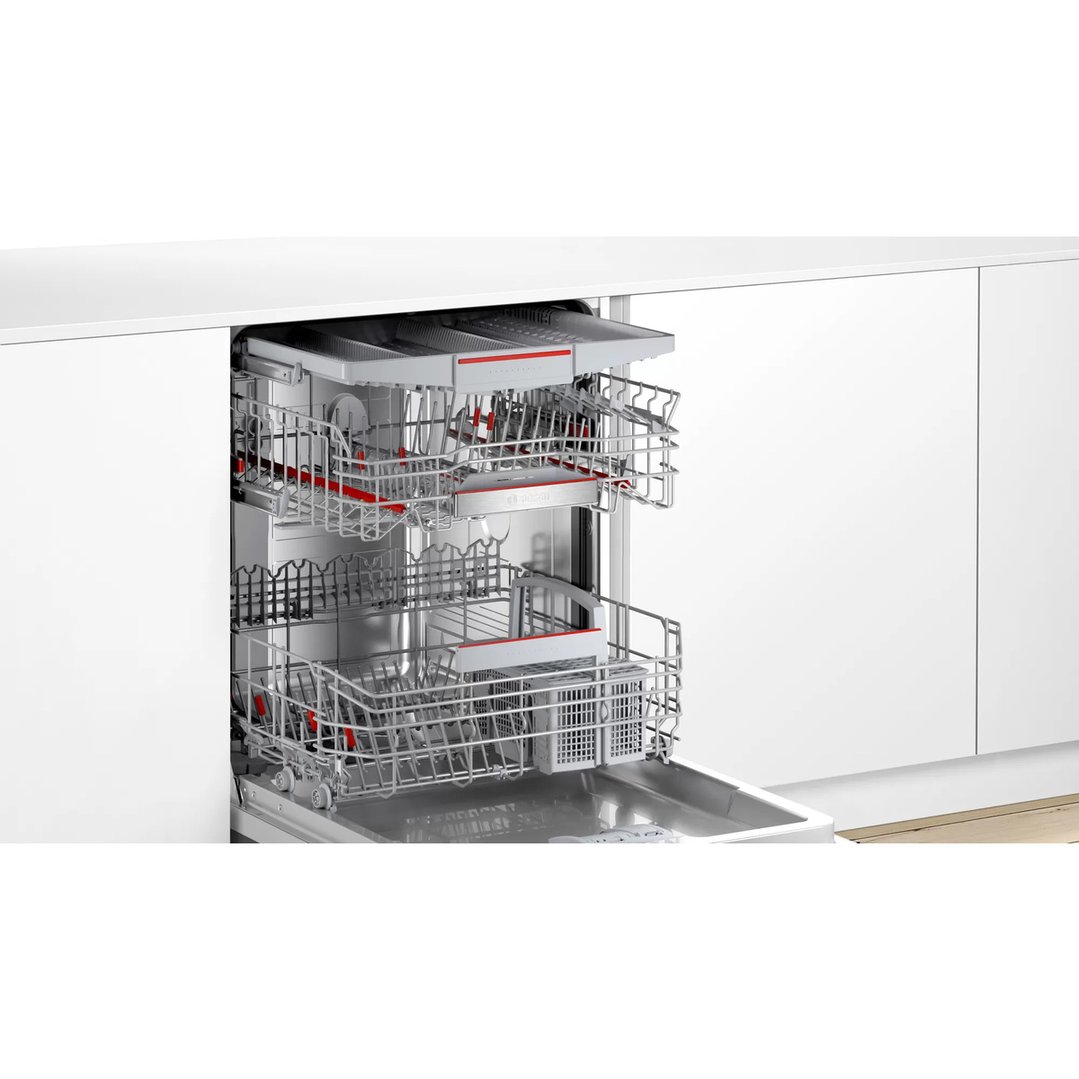 Open Bosch dishwasher with three racks in a white kitchen setting