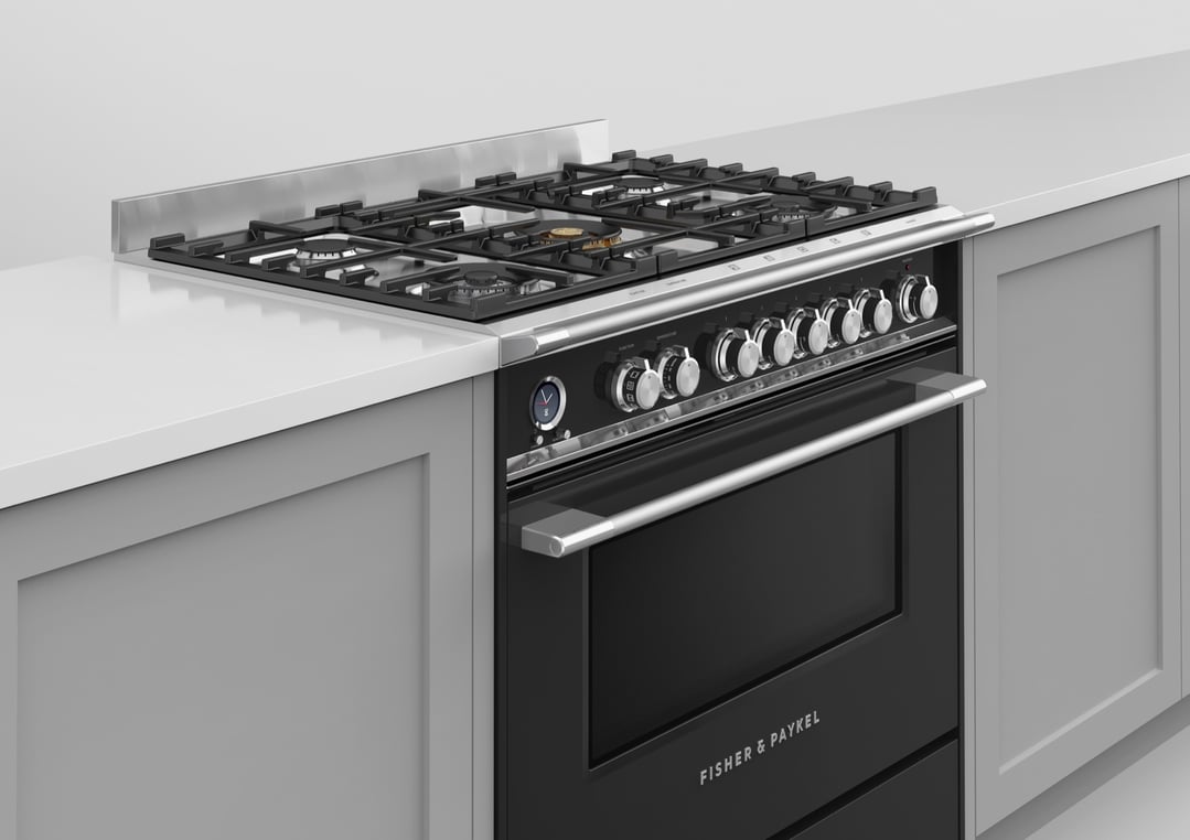Black dual fuel pyrolytic cooker with gas hob in a kitchen setting