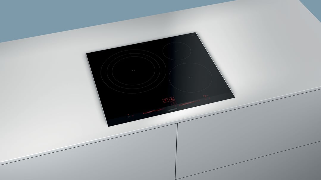 Black Siemens induction cooktop built into a light grey kitchen counter
