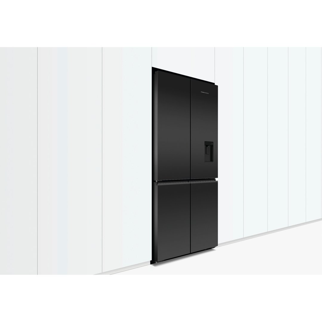 Black quad door refrigerator freezer with ice and water dispenser in a kitchen