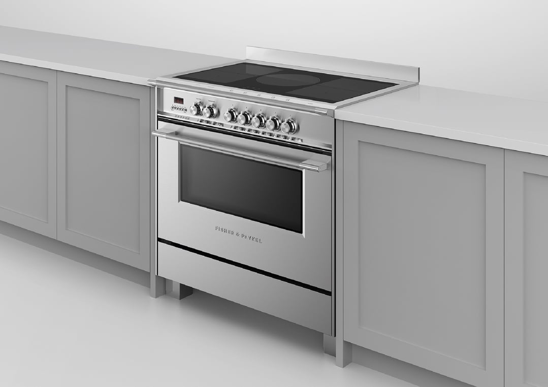 A stainless steel induction cooker in a kitchen with light grey cabinets