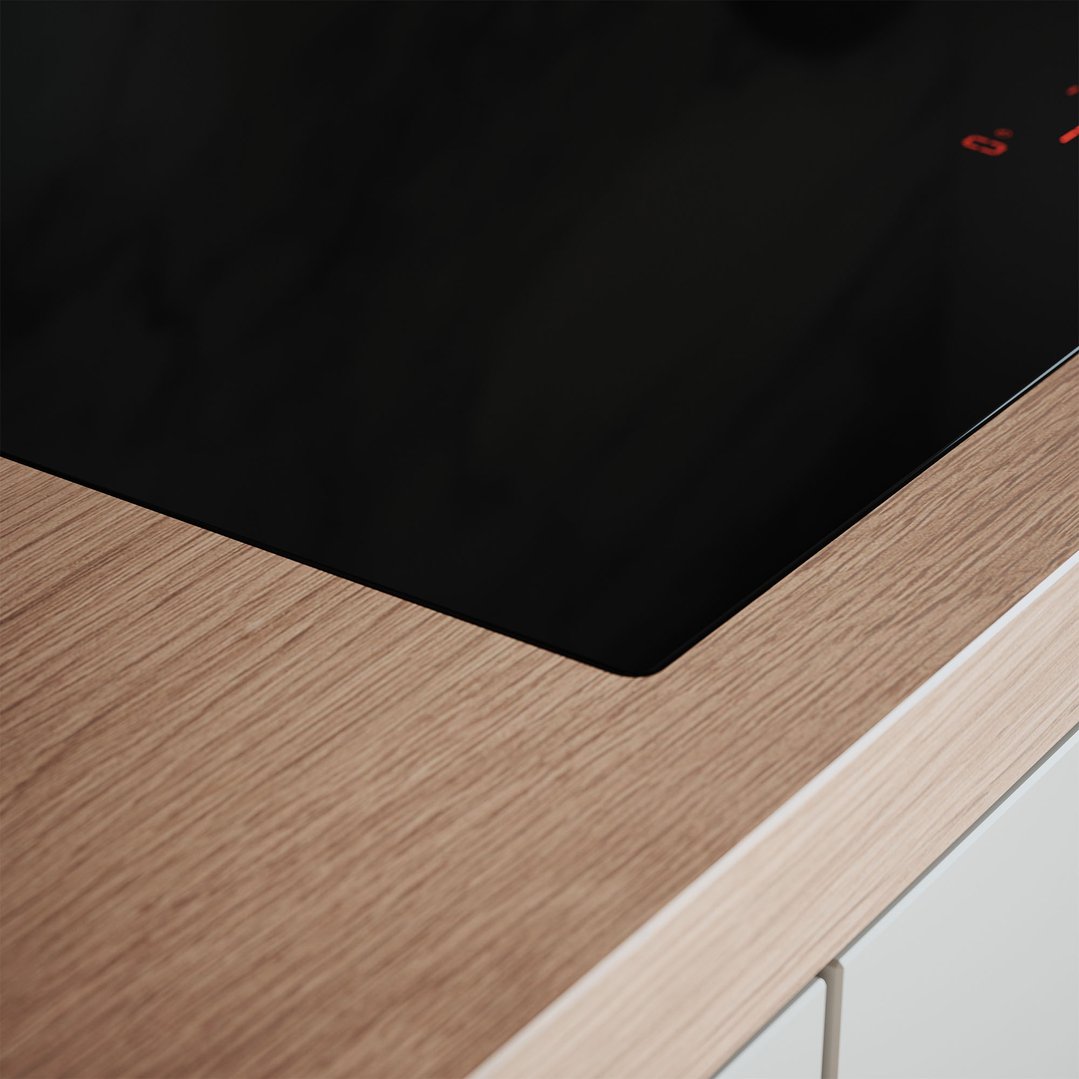 Close up of a black induction cooktop integrated into a wooden countertop