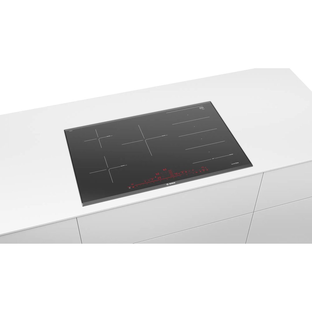 Black Bosch induction cooktop with red display lights on a white countertop