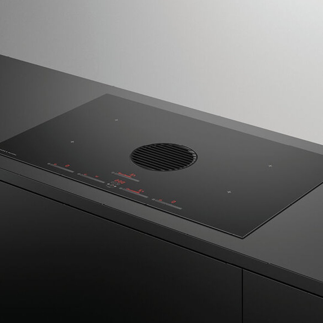 Black induction cooktop with integrated ventilation in a modern kitchen setting