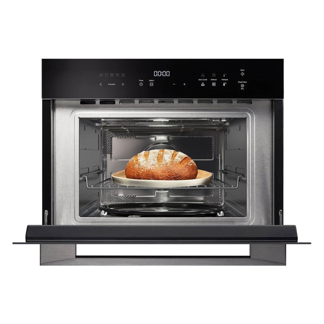 Built-in microwave oven combo with a loaf of bread on a plate inside