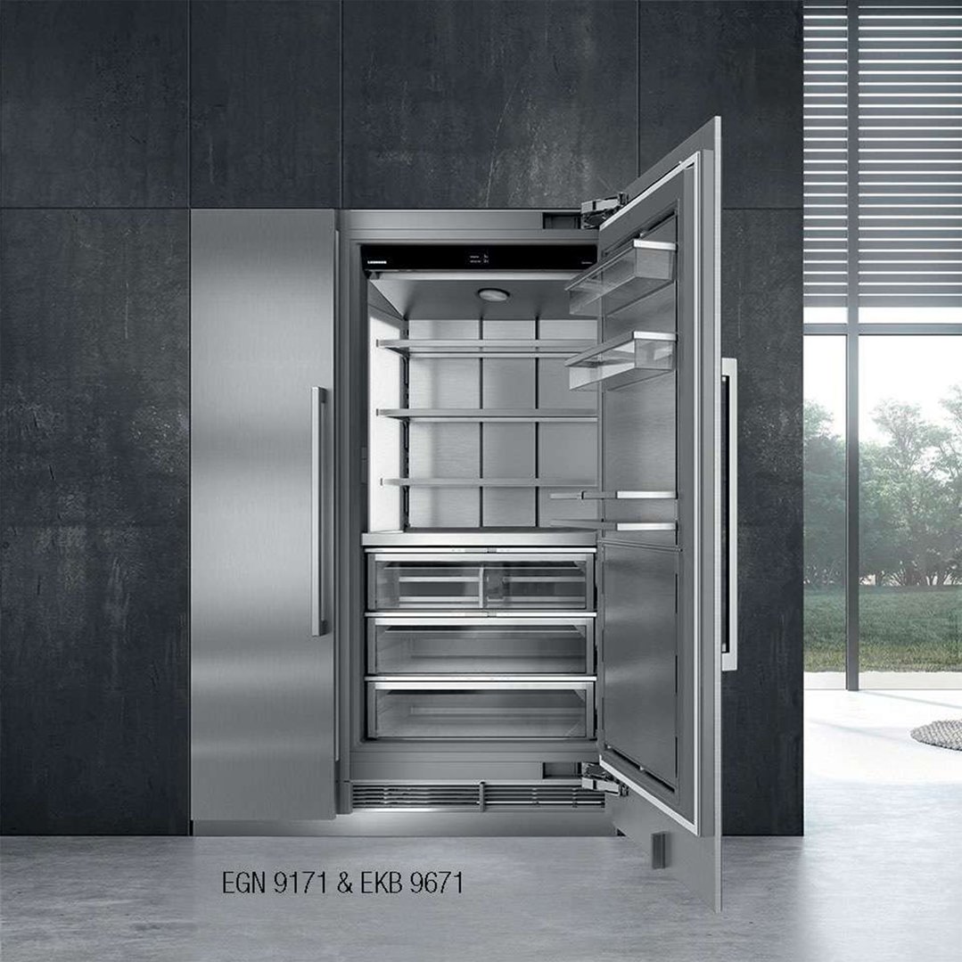 Integrated fridge with open door in a modern kitchen setting