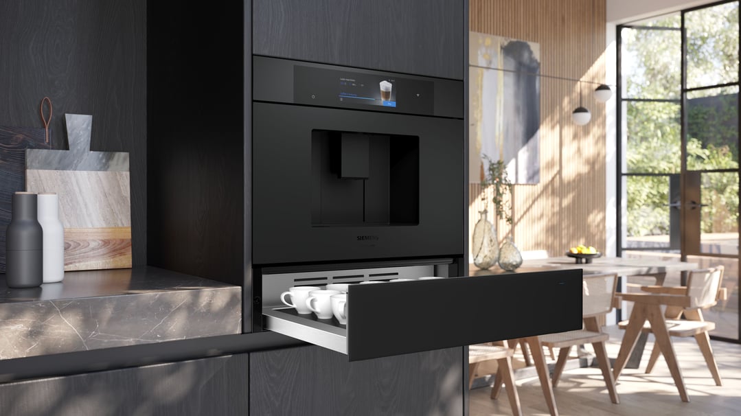 Built-in coffee machine and warming drawer in a modern kitchen setting