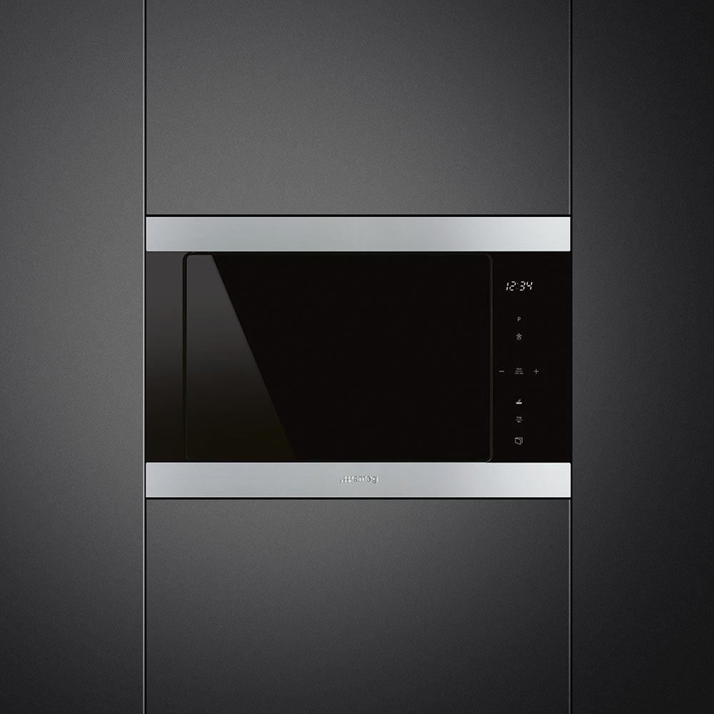 Built-in microwave oven integrated into dark grey kitchen cabinetry